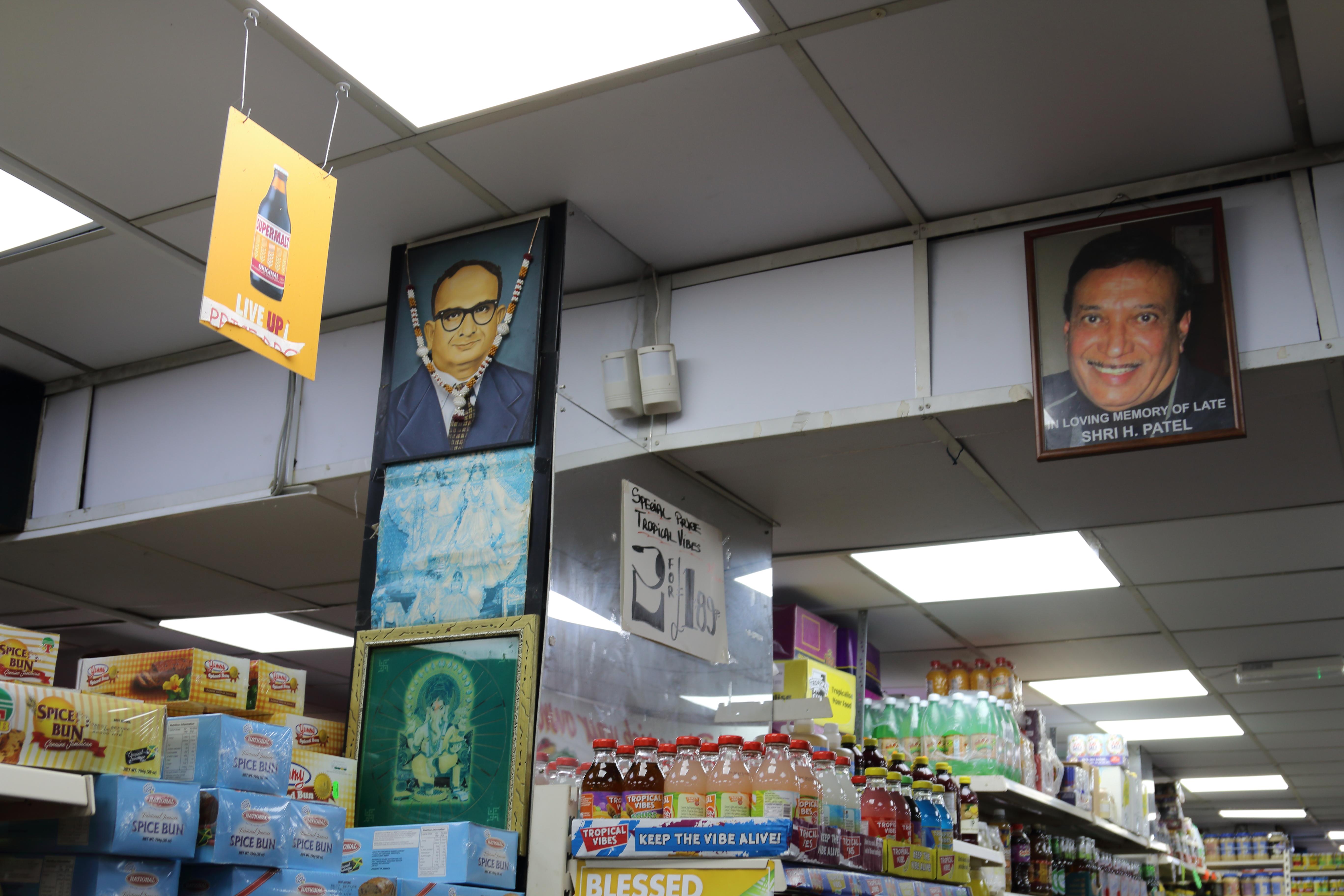 Inside Blue Mountain Peak grocery store, showing photographs of Harshad Patel, the founder of the shop.